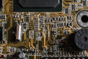 pexels-photo-6755083 Detailed close-up of a circuit board showing various electronic components and traces.