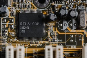 pexels-photo-6755091 Detailed image of a motherboard highlighting a RTL8100BL microchip.